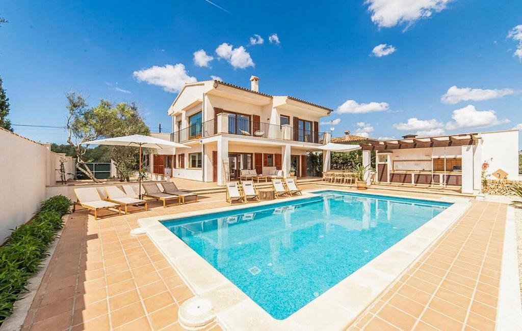 a house with a swimming pool in front of a house at Casa Vistamar in S'Estanyol de Migjorn