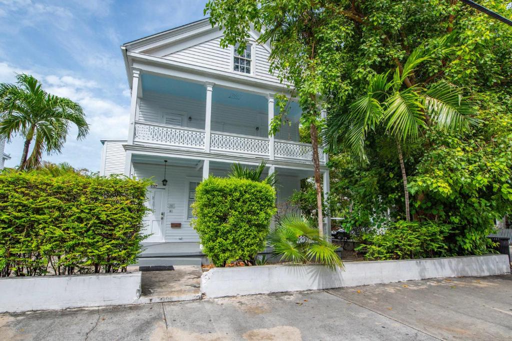 a white house with trees in front of it at Sweet Caroline in Key West