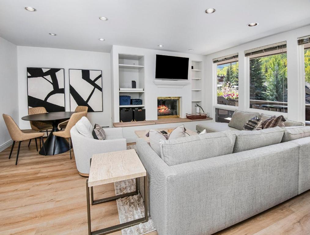 a living room with a couch and a table at Alphorn #A202 in Vail