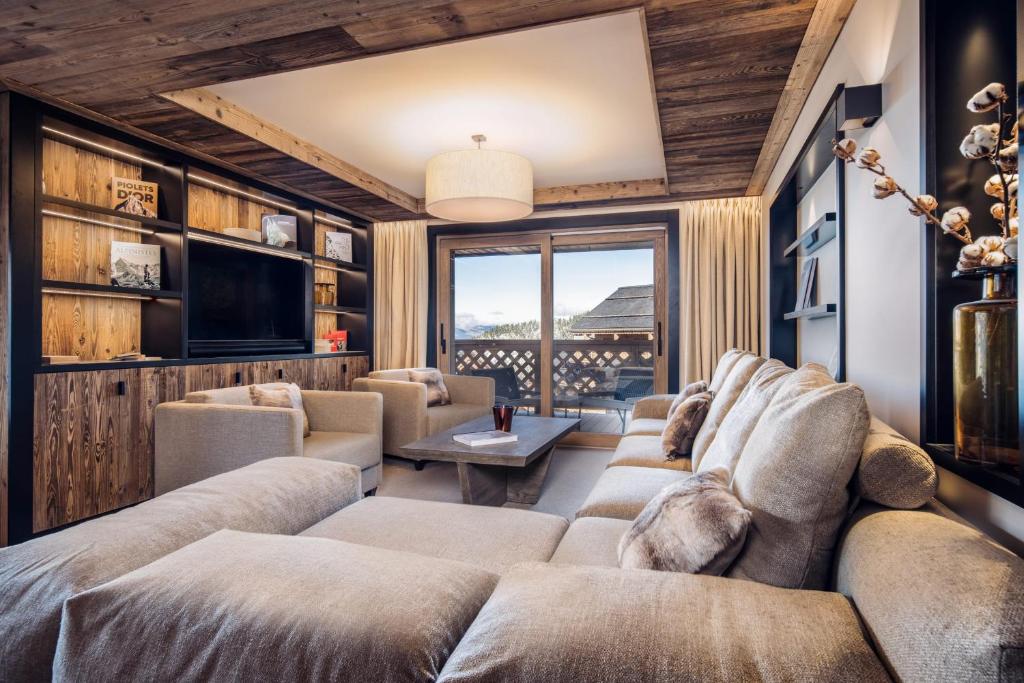 a living room with a couch and a tv at Antarès SIRIUS 302 - Ski inski out family apartment in Méribel