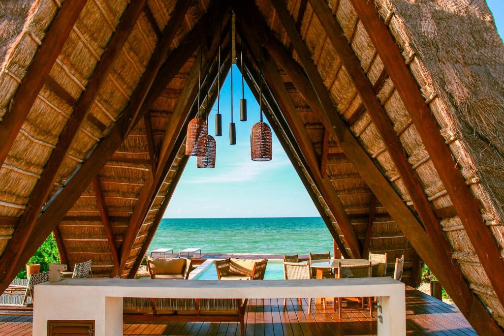 a room with a view of the ocean through a window at Lipsos Retreat Concierge Villa in Progreso