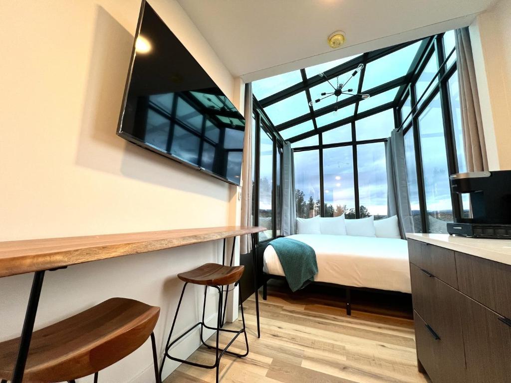 a bedroom with a bed and a large window at Wild Sage in Orderville