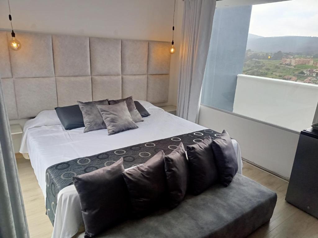 Postel nebo postele na pokoji v ubytování Mirador samsara Penthouse con Jacuzzi al aire libre,piso completo