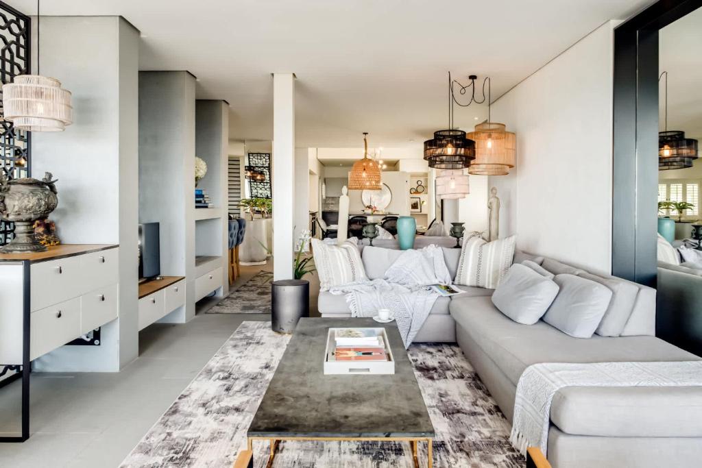 a living room with a couch and a table at Ocean Vue in Cape Town