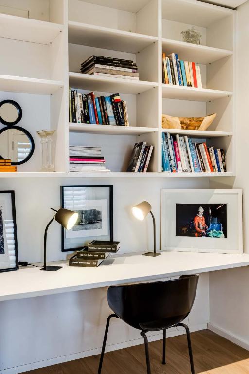 a white desk with a chair and books at Ocean Vue in Cape Town