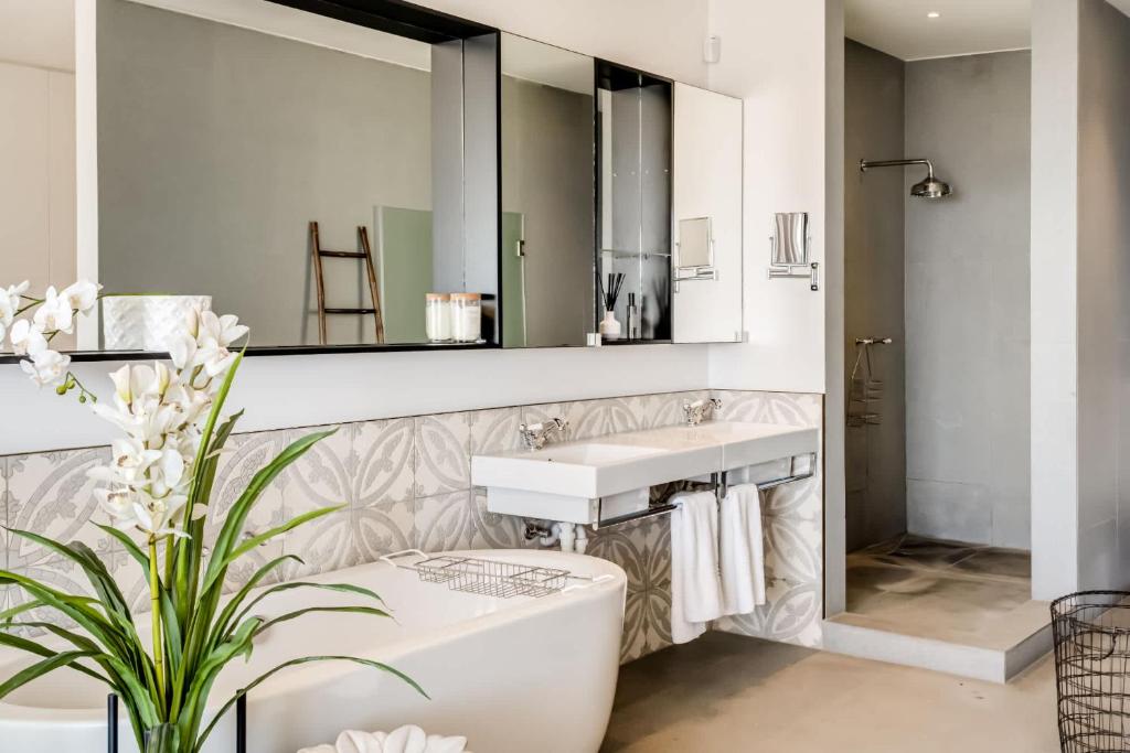 a bathroom with a sink and a toilet and a mirror at Ocean Vue in Cape Town