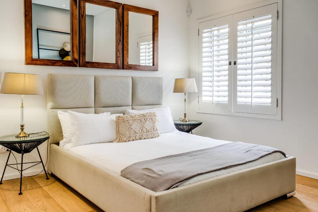 a bedroom with a large bed with two end tables at Ocean Vue in Cape Town