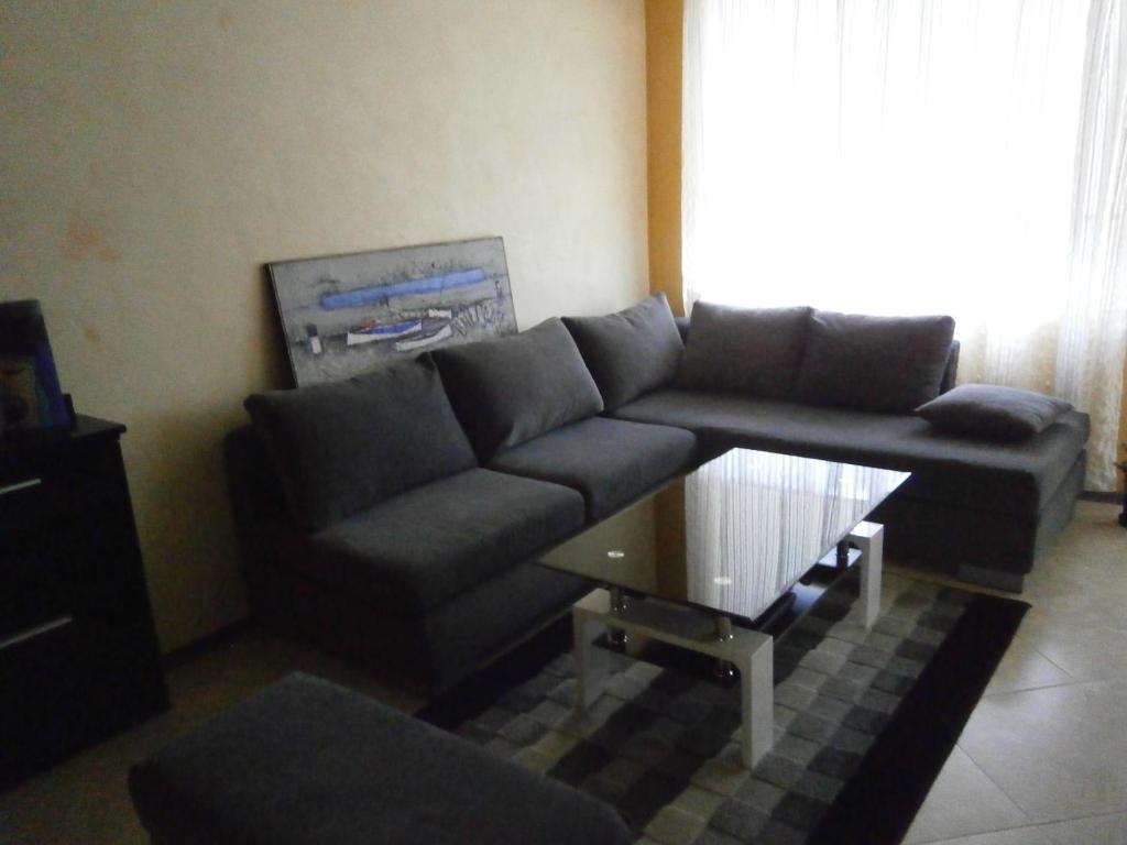 a living room with a couch and a table at Art apartment Kiril and Metodi square in Burgas