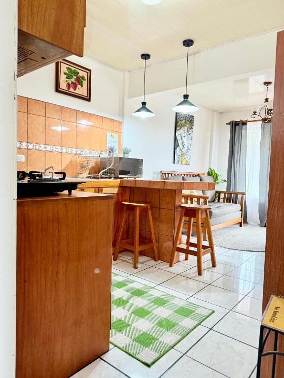 a kitchen with a wooden counter and a table at Sweet Home Carrión in Fortuna