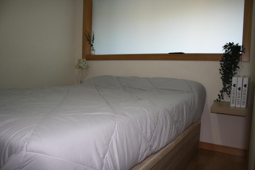 Ένα ή περισσότερα κρεβάτια σε δωμάτιο στο Apartamento A Cabana II
