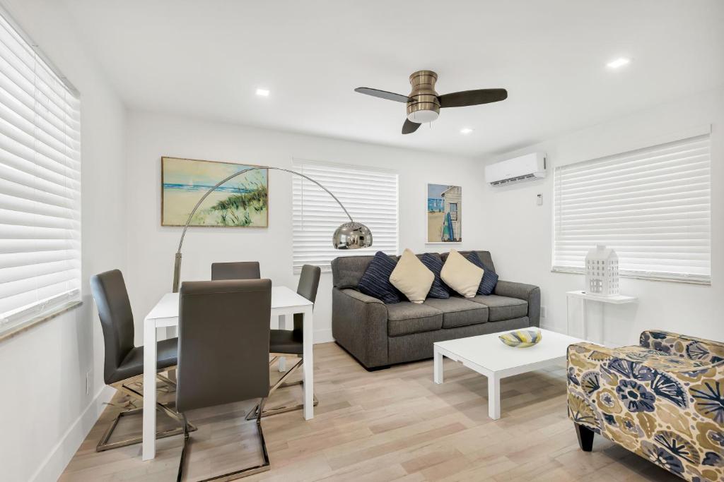 a living room with a couch and a table at ULTRA spacious apartment steps from the beach in Hollywood