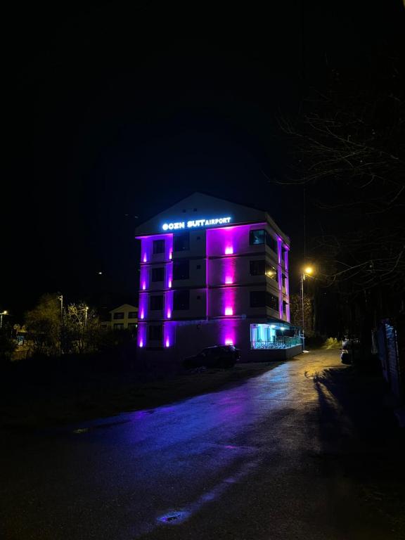 a building with purple lights on it at night at Ozn Suit Airport Hotel in Arnavutköy