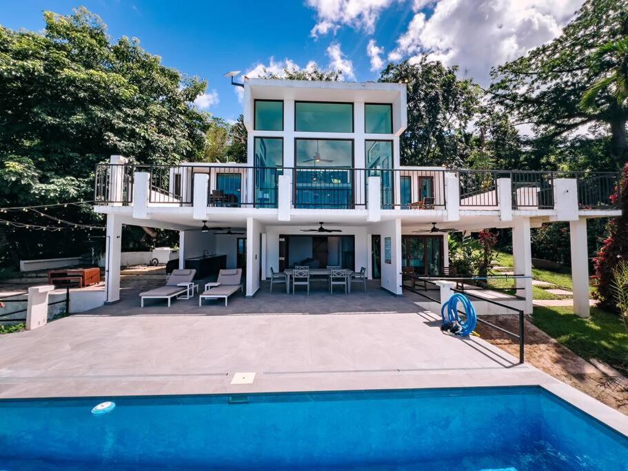 a villa with a swimming pool and a house at Yunque Reserve Secluded Rainforest House in Hato Candal