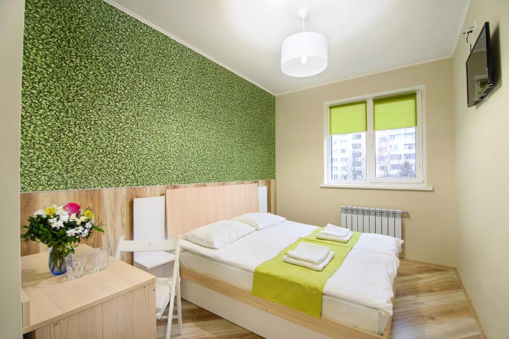 a bedroom with a bed and a desk and a television at Urban Hotel in Lviv