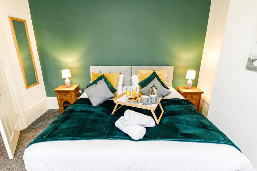 a bedroom with a large bed with a table on it at 3Bed Cottage - WiFi & Parking - Perfect for Contractors in Sunderland