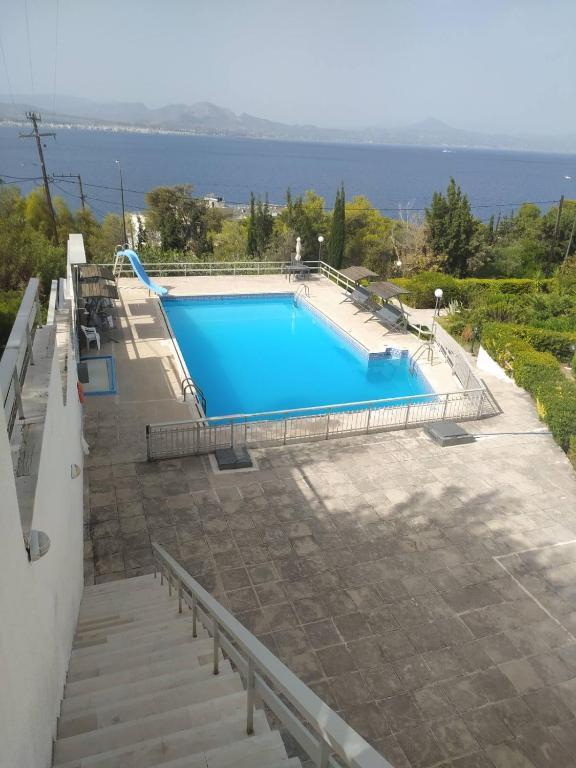 a swimming pool with a view of the water at Endless Blue in Loutraki