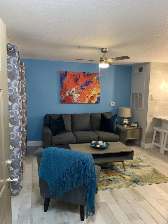 a living room with a couch and a table at Villa del Sol in Kissimmee