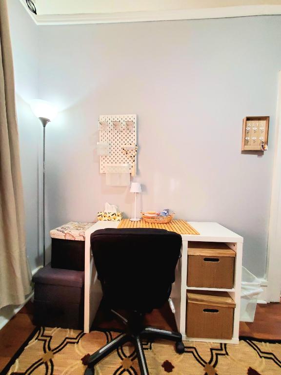 an office with a desk and a chair and a desk and a lamp at Merj's Guest House in Wolesly in Winnipeg