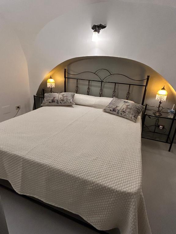 a bedroom with a large white bed with two pillows at Farrose in Naples