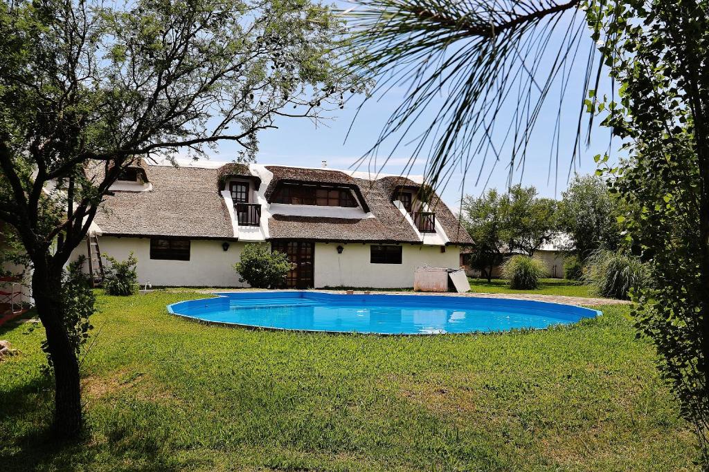 une maison avec une piscine dans la cour dans l'établissement Hosteria de Campo Valdemoro, à Gualeguaychú