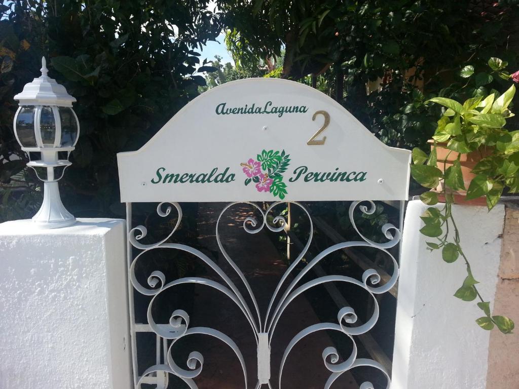 a sign on a gate next to a lamp at Apartment Smeraldo in Bayahibe