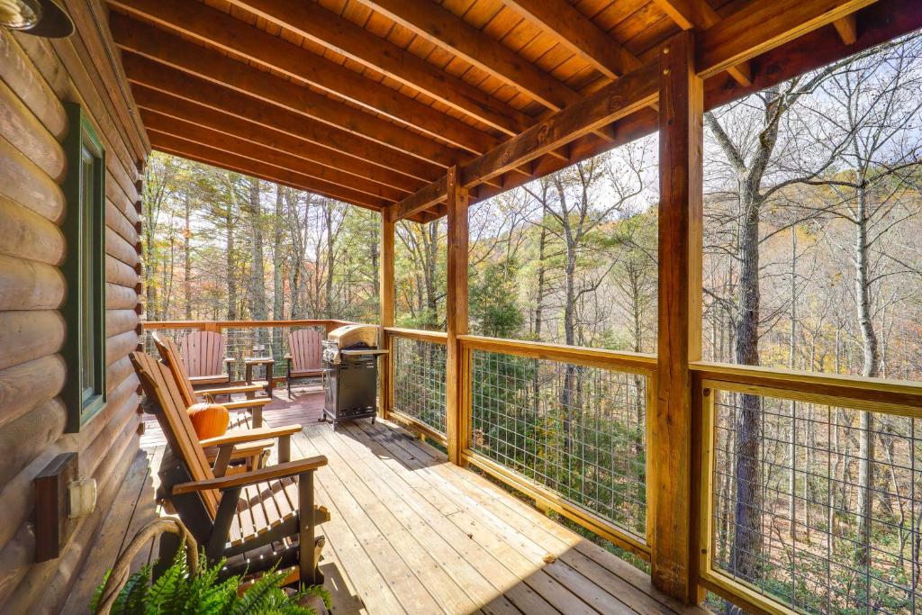 a screened in porch with two chairs and a grill at Cabin on 22 Acres with Patio - 3 Mi to Blowing Rock! in Lenoir