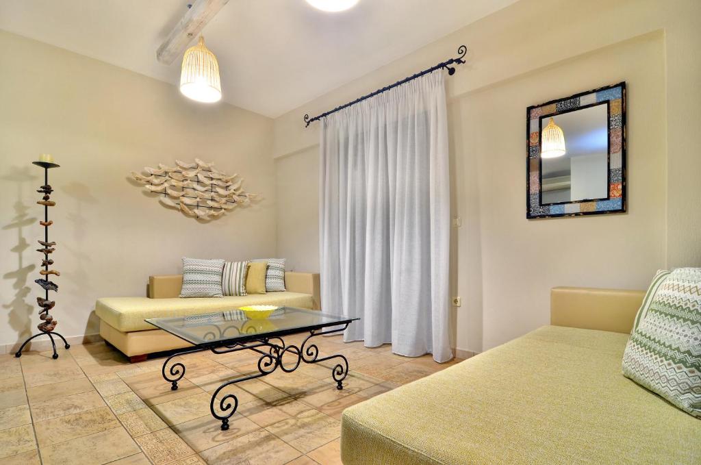 a living room with a couch and a table at Niriides Luxury Apartments in Syvota