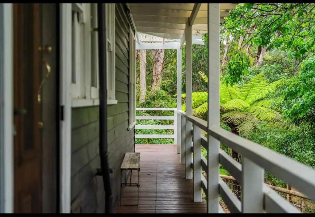 a porch of a house with a bench on it at Warburton Bushland Retreat in Warburton