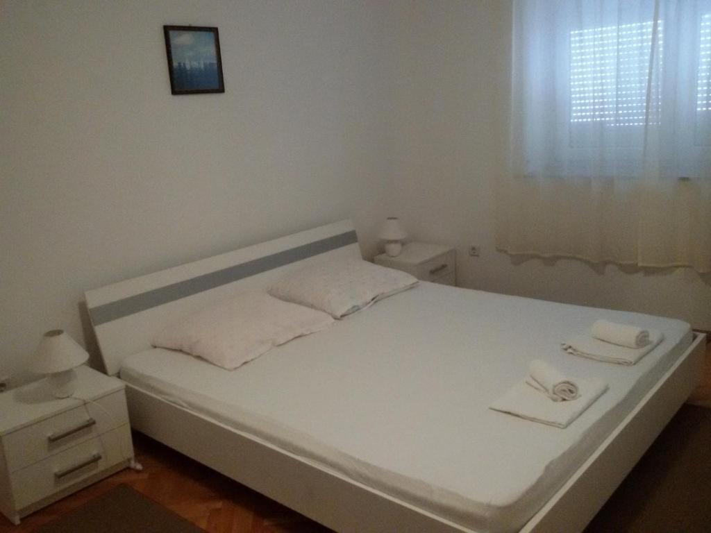 Posteľ alebo postele v izbe v ubytovaní Apartments Grkinić