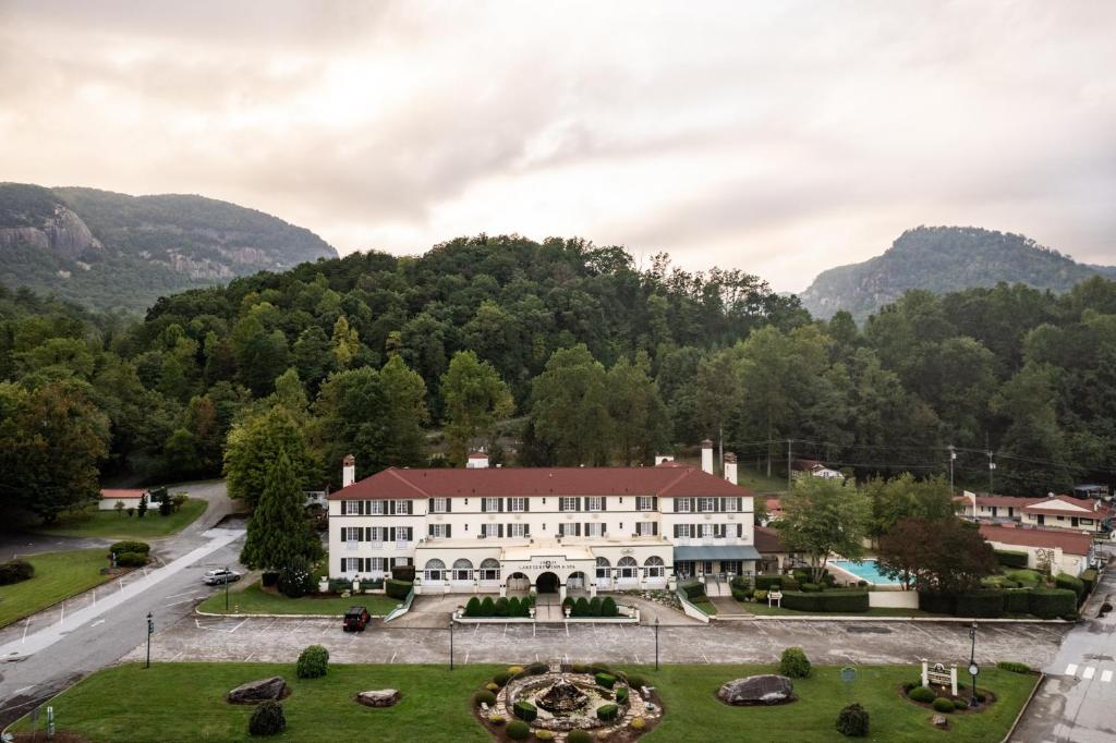 an aerial view of a building with mountains in the background at Lake Lure Inn and Spa in Lake Lure