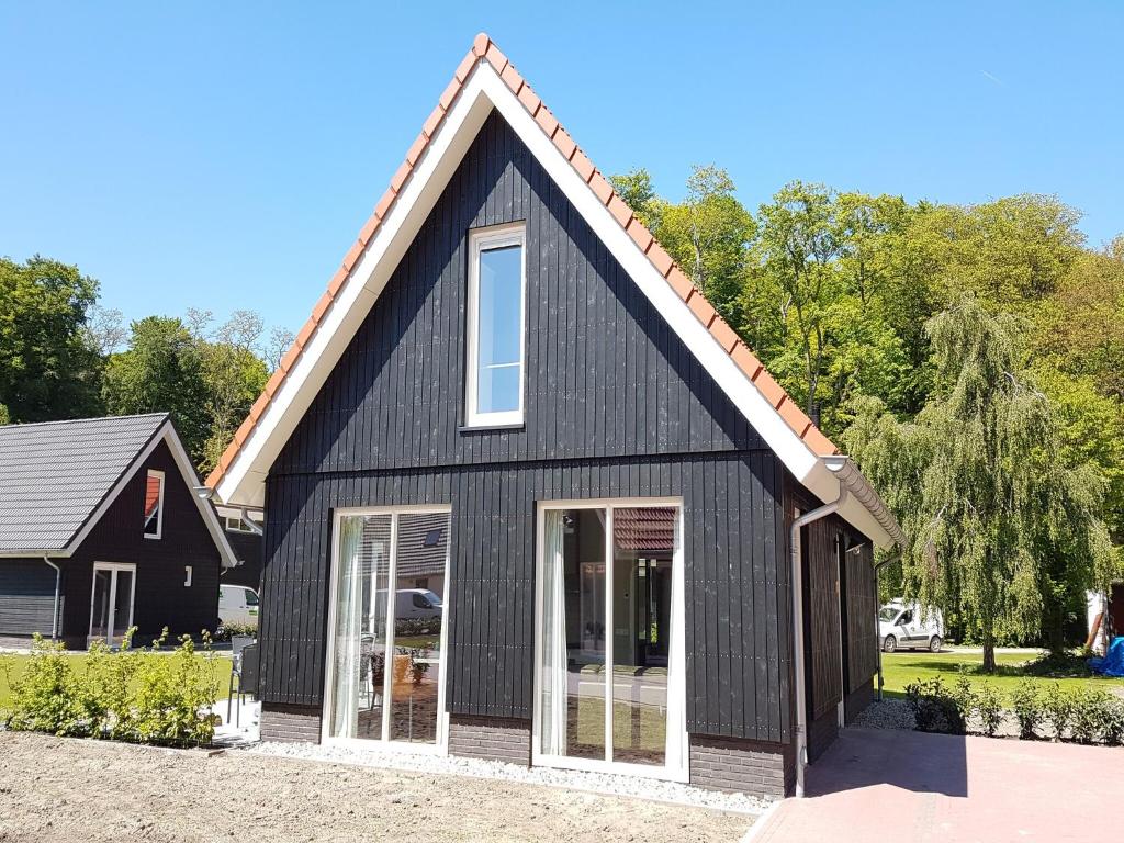 a black house with a gambrel roof at Modern Villa with Garden in Almen