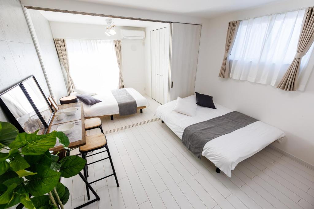 En eller flere senge i et værelse på しっぽタウンホテル岸里駅