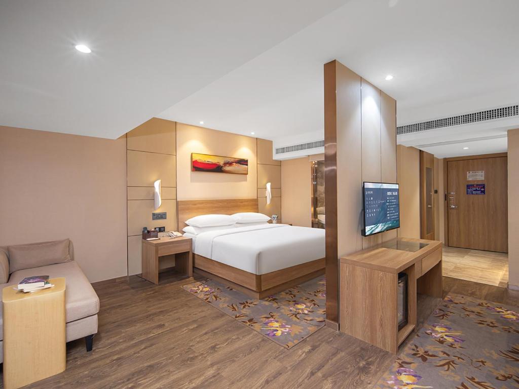 Postel nebo postele na pokoji v ubytování Guangzhou Baiyun Airport Renhe Cornet International Chain Hotel