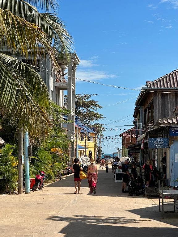 a group of people walking down a street at Lazy Bones in Koh Rong Sanloem