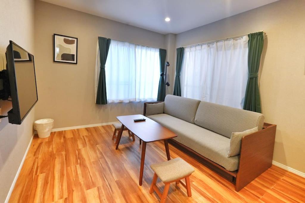 a living room with a couch and a table at ZJ301 Hanama301 The Skytree Residence A Newly Home by Tokyo Iconic Landmarks in Tokyo
