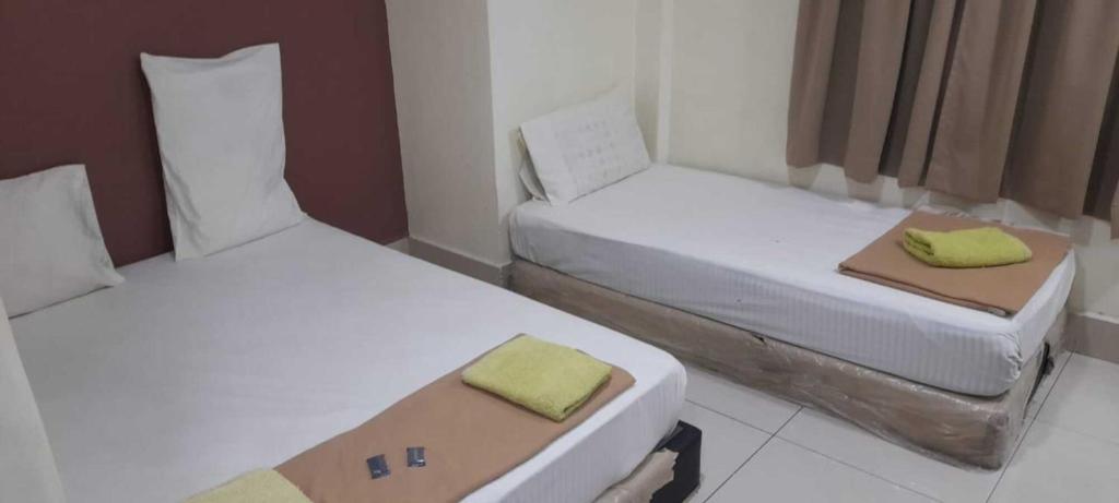 Postel nebo postele na pokoji v ubytování SV Andalas Hotel