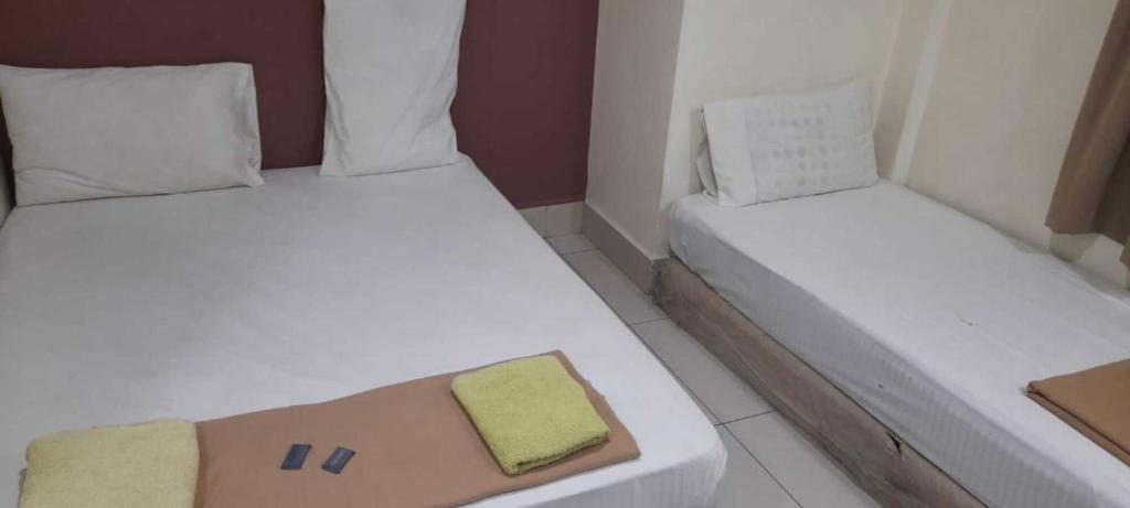 Postel nebo postele na pokoji v ubytování SV Andalas Hotel