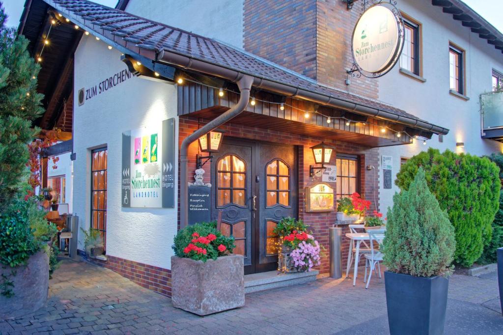 a restaurant with flowers in front of a building at Apartment Landhotel Zum Storchennest in Bann