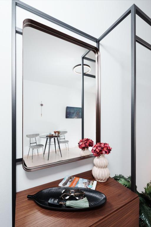 a mirror on top of a wooden table at Libyan Sea Suites in Ierápetra