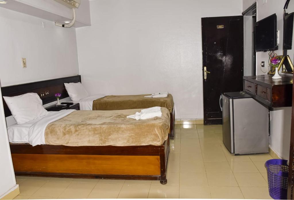 Postel nebo postele na pokoji v ubytování Oscar Hotel