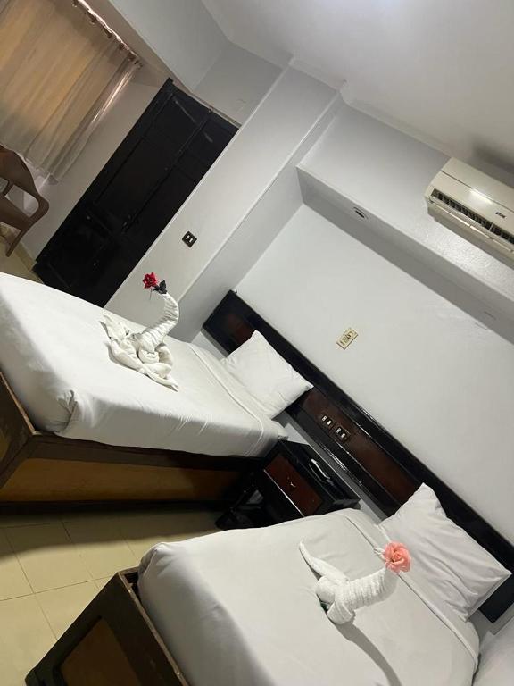 Postel nebo postele na pokoji v ubytování Oscar Hotel