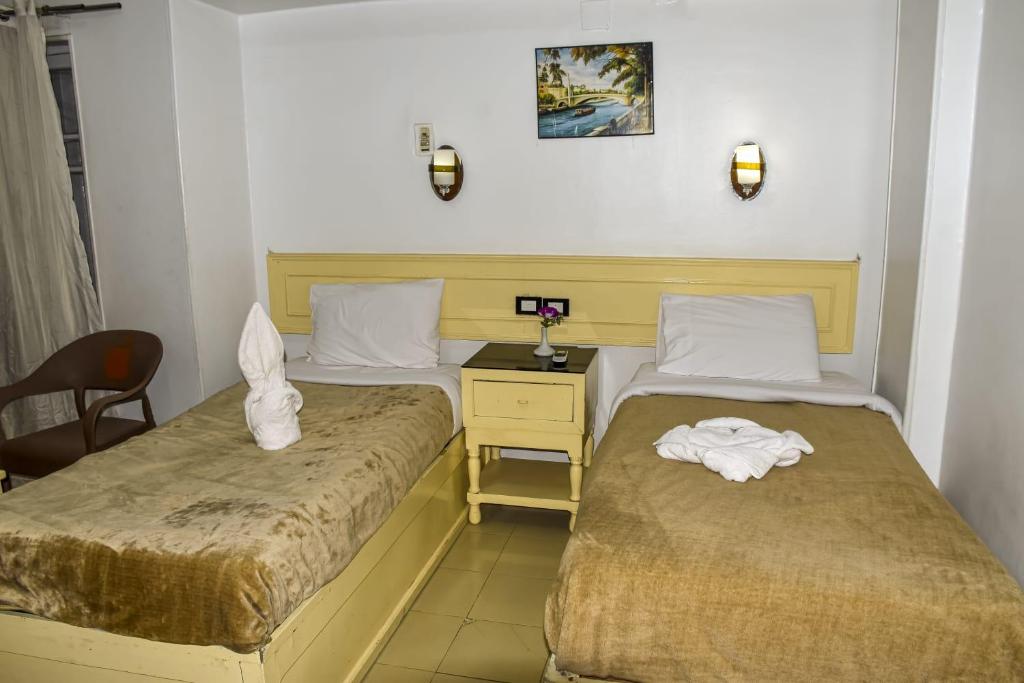 Postel nebo postele na pokoji v ubytování Oscar Hotel