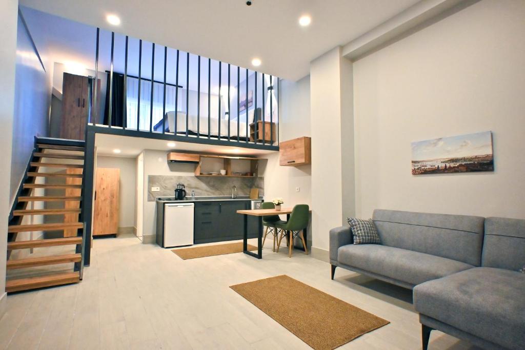 a living room with a couch and a kitchen at Central location LOFT Apartment in Avcılar