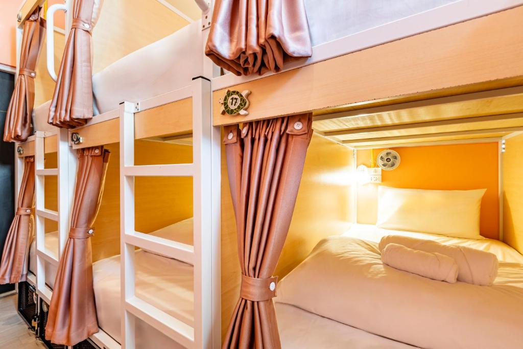 a bunk bed in a room with two bunk beds at Sweett Lemon Hostel in Patong Beach
