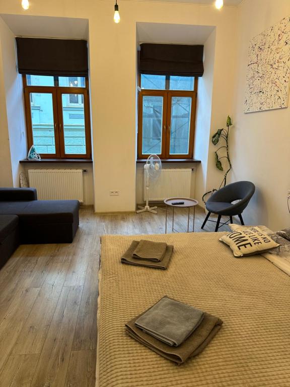 a living room with a bed and a couch at Apartment VIP Virmenska Street in Lviv