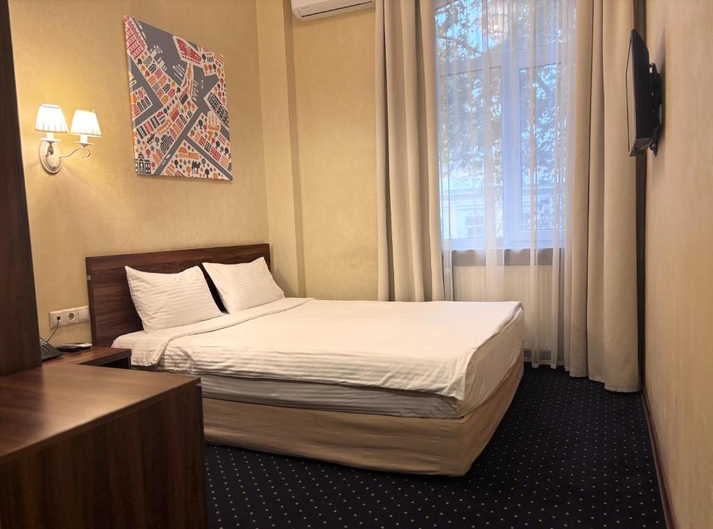 Postel nebo postele na pokoji v ubytování Odeska Astoria