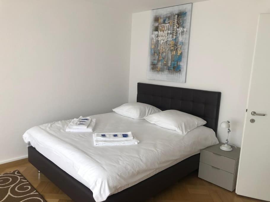 a bedroom with a bed with a book on it at Bright studio in the city center - Greenyard 1 in Zürich