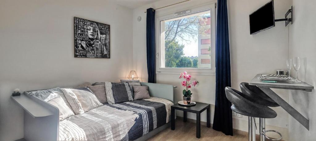 een slaapkamer met een bed en een raam bij Cosynestdunkerque, au Coeur de Dunkerque, 2 personnes, parking privé in Duinkerke