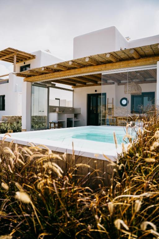 an external view of a house with a swimming pool at Villa ilios, Stelida Naxos, by NaxosVibe in Naxos Chora