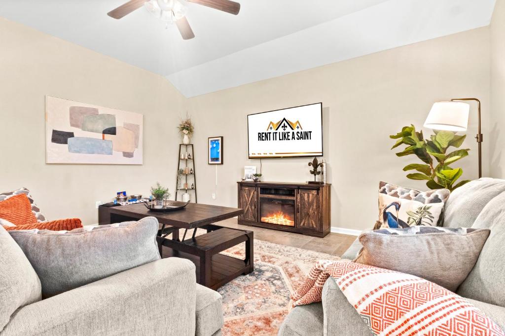 a living room with two couches and a fireplace at 3BR Retreat Plush Beds High-Speed Wi-Fi in Lake Charles